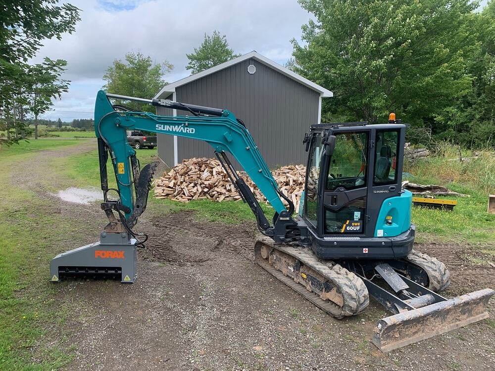 Sunward SWE60UF excavator with a Forax mulching head, parked at our yard in Steeves Mountain, New Brunswick